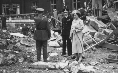 Queen Elizabeth and King George survey the damages after the Royal Chapel at Buckingham Palace is reduced to rubble after being destroyed by a Nazi bomb attack in September of 1940.